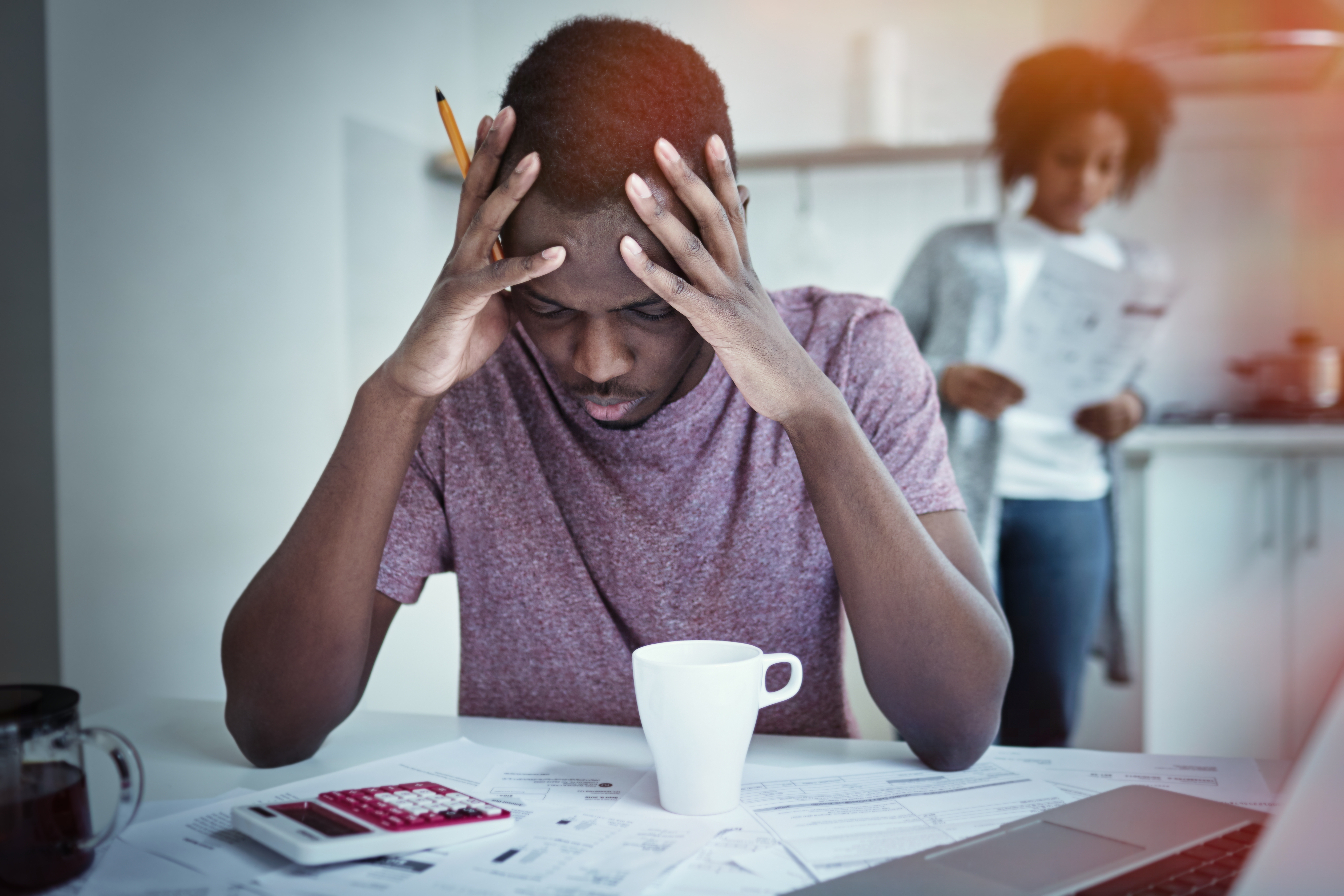 Man looking stressed about bills representing financial impact of injury and loss of income
