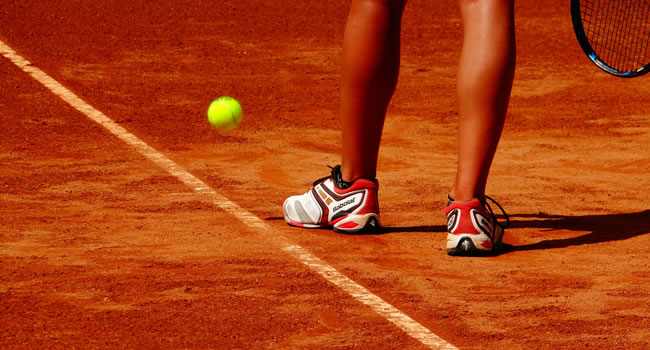 Close-up of tennis player preparing to serve showing focus, technique and preparation