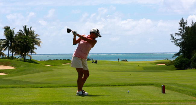 Golf player mid-swing showing strain on the body during play