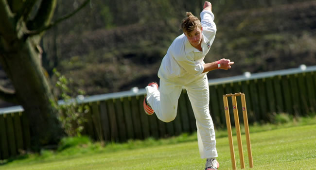 Cricketer bowling a ball demonstrating physical demands and injury risk in cricket