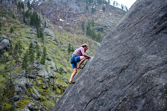 Rock climber using ropes during a steep outdoor ascent in the UK