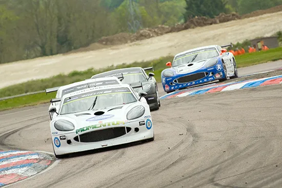Sports cars racing on track demonstrating speed and endurance in motorsport