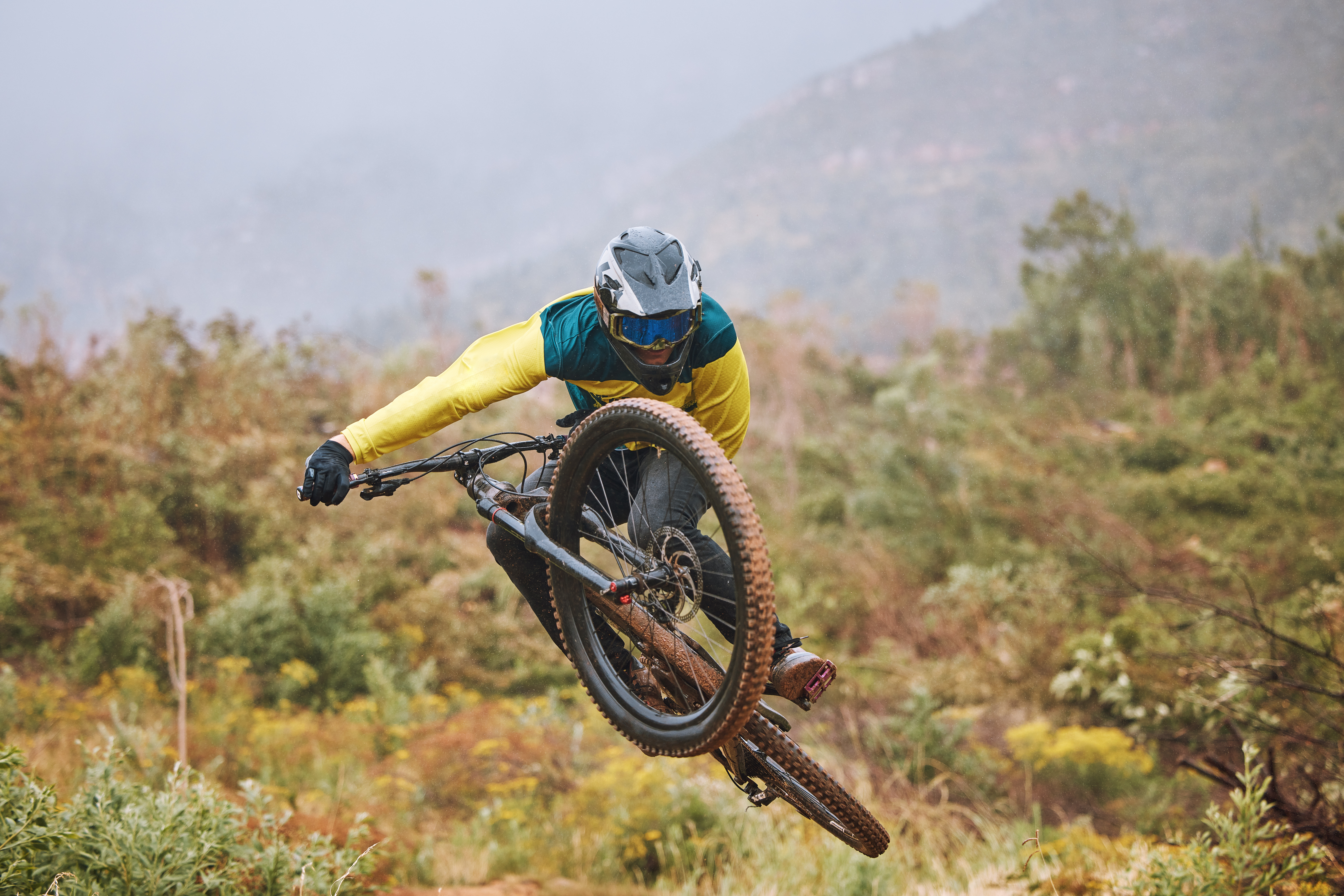 Mountain biker performing a jump demonstrating skill, height and risk in mountain biking